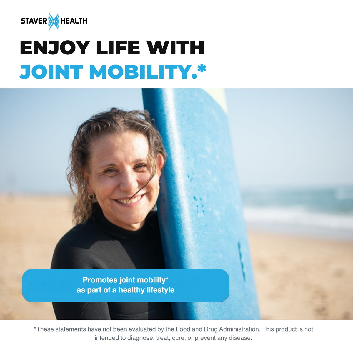 Smiling woman in a wetsuit holding a surfboard on a sunny beach