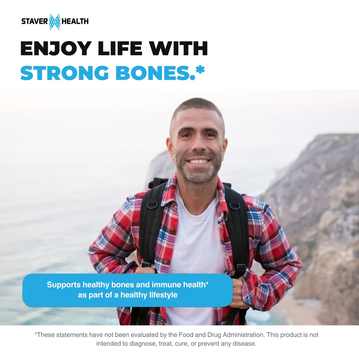 Smiling man with a backpack hiking on sunny sea cliffs